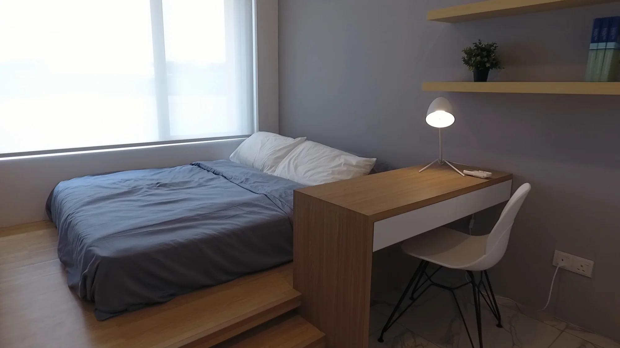 Bedroom on a raised platform with a built-in study desk