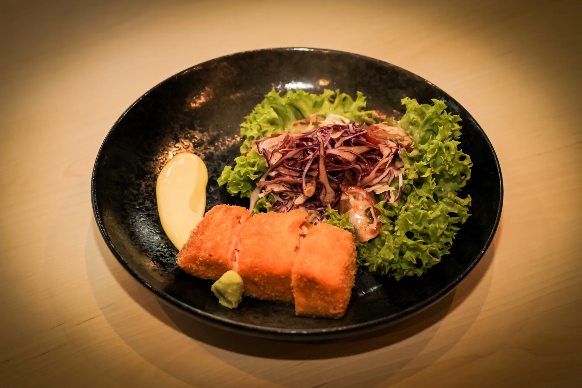 Momochan dish plated on a dark stone plate