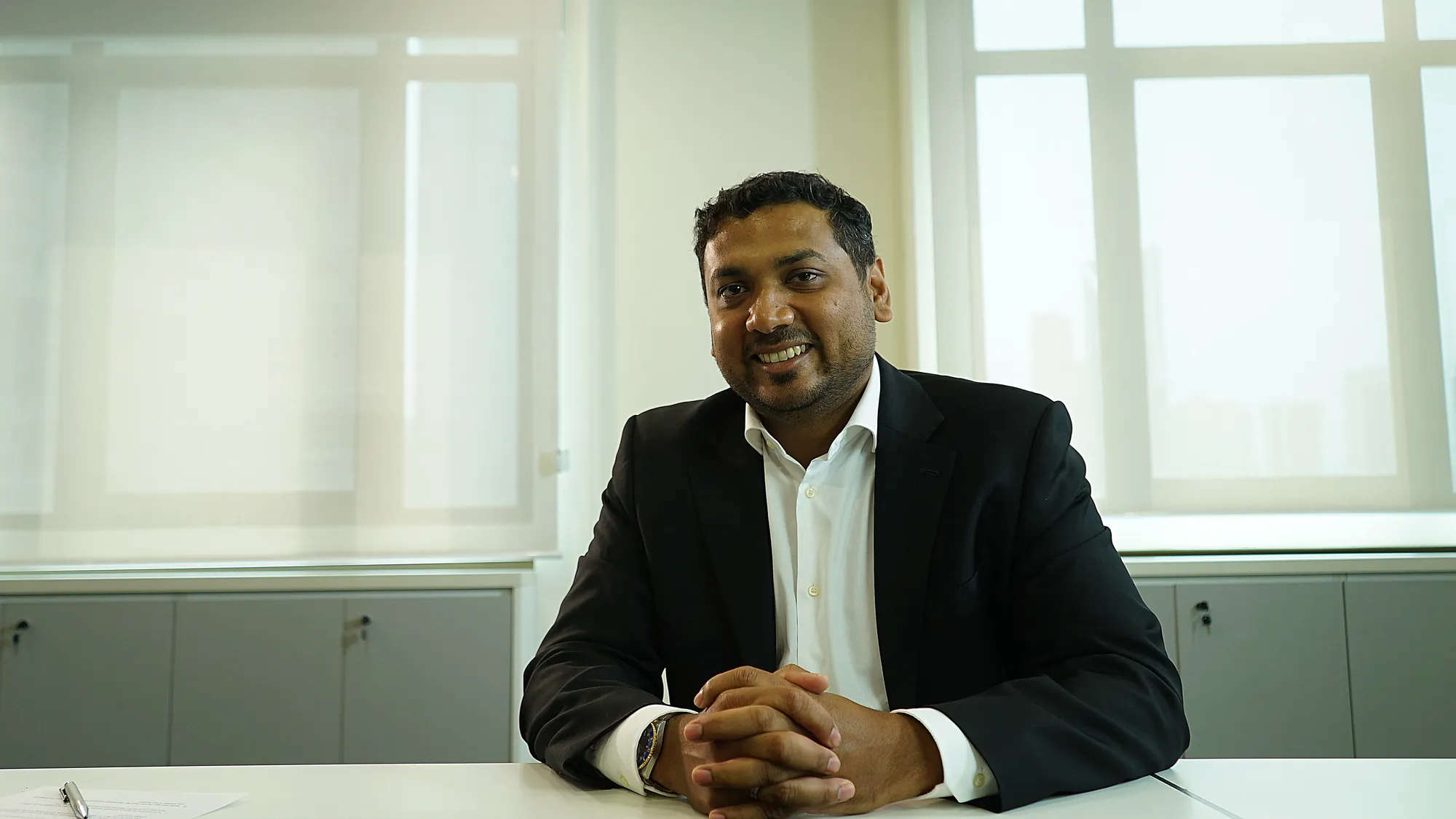 PESB interviewee seated at a desk in a bright office