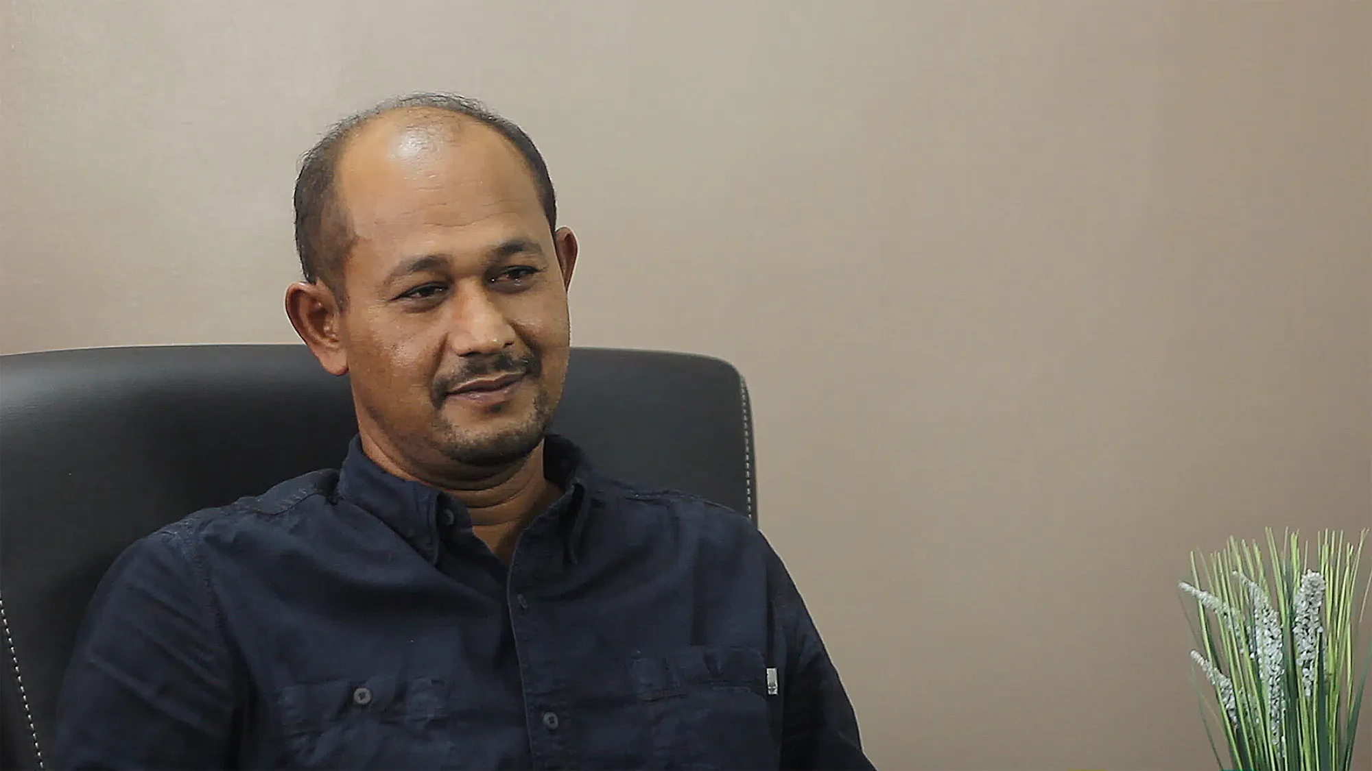 PESB interviewee seated in an office chair