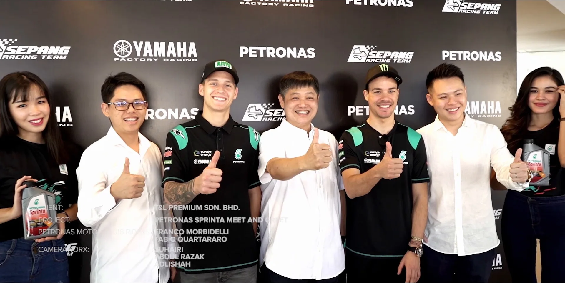 Riders and brand team giving thumbs up at the Sprinta backdrop