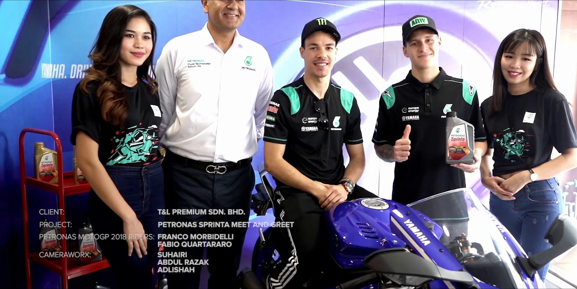 Riders seated on a Yamaha with Petronas Sprinta bottles
